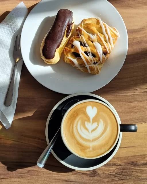 Coffee and pastries on a table at Cafe B’Loc