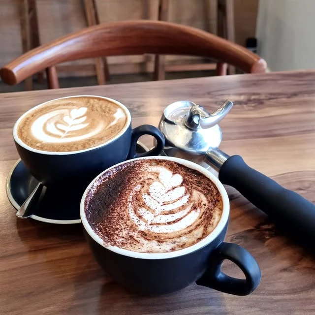 Two coffees with latte art at Cafe B’Loc